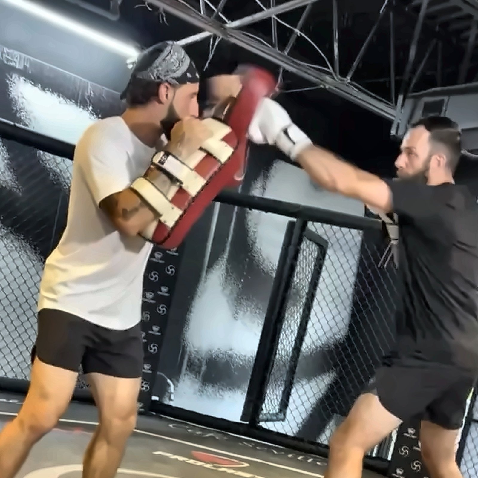 One-on-one pad work in the Undisputed cage